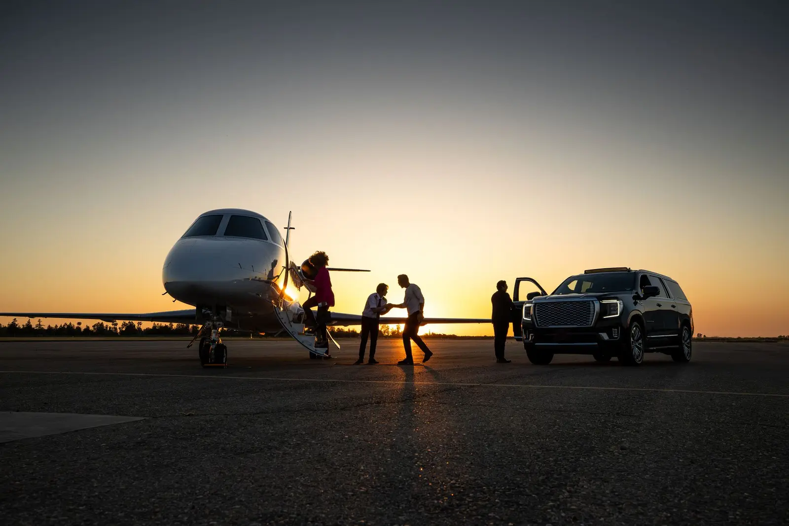 Chicago Executive Limousine chauffeur greeting arriving travelers beside a private jet at O’Hare